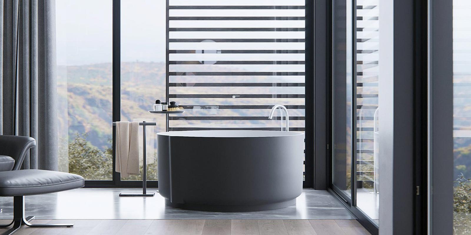 Ein modernes Badezimmer mit einer runden Badewanne, großen Fenstern und einem atemberaubenden Blick auf die Landschaft.