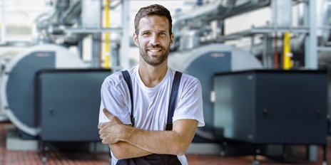 Ein Anlagenmechaniker der seine Arme verschränkt