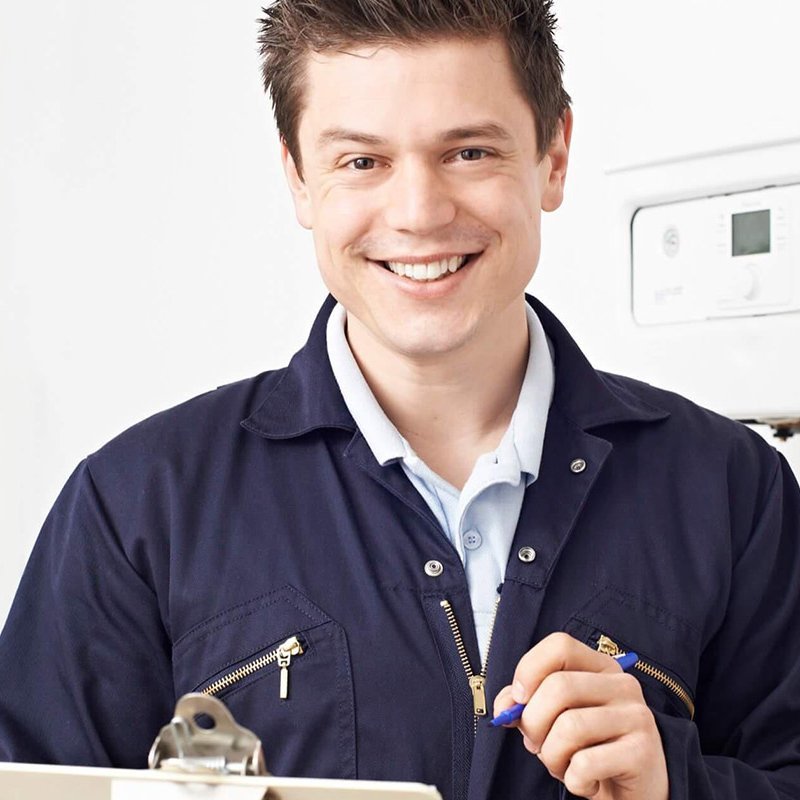 Ein junger Anlagenmechaniker mit einem Klemmbrett in der Hand